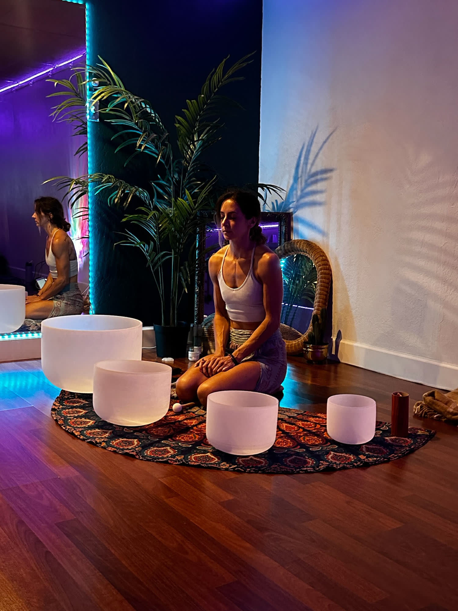 Shelby Von Oepen seated in meditation with crystal singing bowls