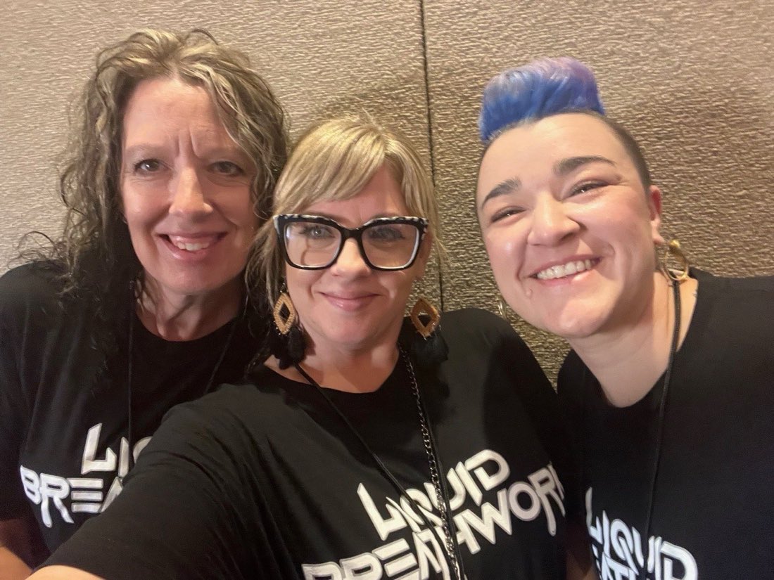 Liquid Breathwork students and graduates smiling together in branded shirts